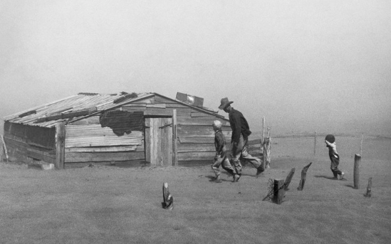 Arthur Rothstein's photograph titled 'Dust Bowl Farmer' depicting a farmer and his two sons enduring a dust storm.