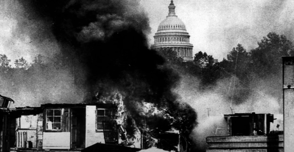 A black and white screenshot of 'Bonus Army' by Harris & Ewing depicting houses engulfed in smoke.