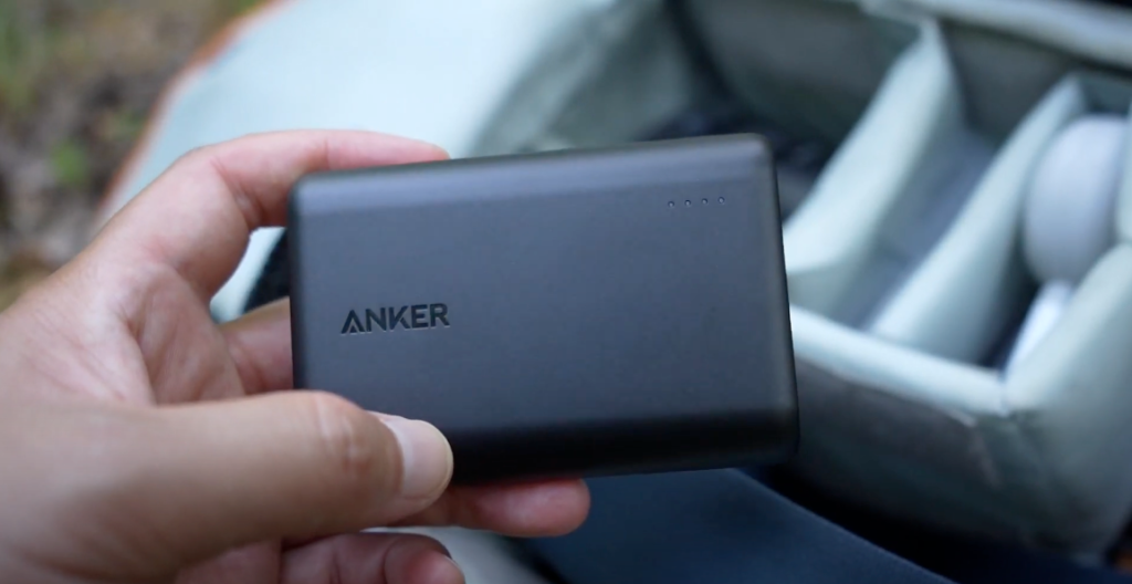 Hand holding an Anker PowerCore 10000 power bank