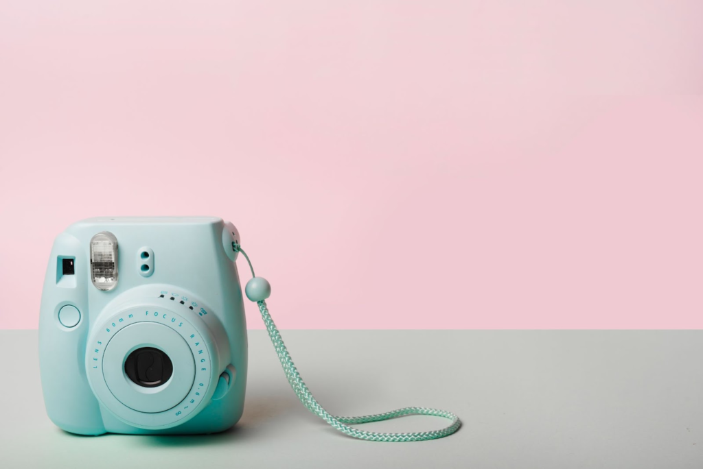 an Instax Mini 11 camera in a soft-colored background 