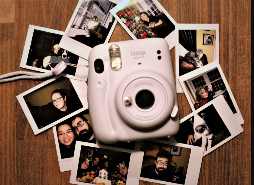 The Instax Mini 11 camera and a bunch of photos of different people