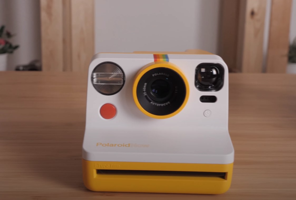 the front of the Polaroid Now camera in white and yellow 