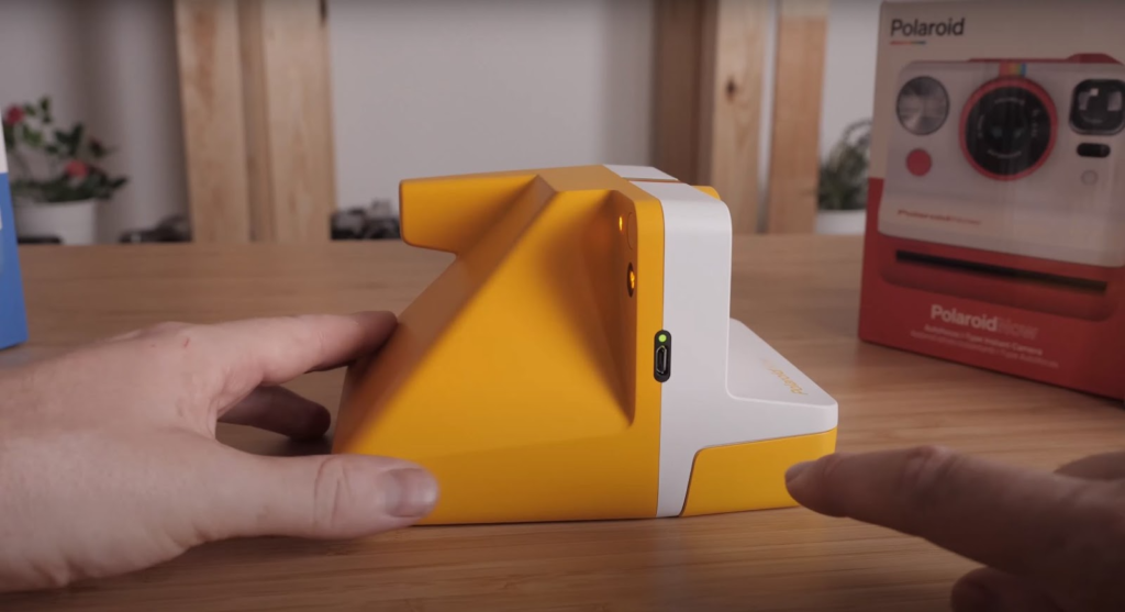 the profile of the Polaroid Now camera showcasing a side button