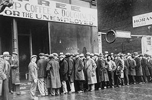 Photo displaying a lengthy queue of individuals waiting outside a soup kitchen.